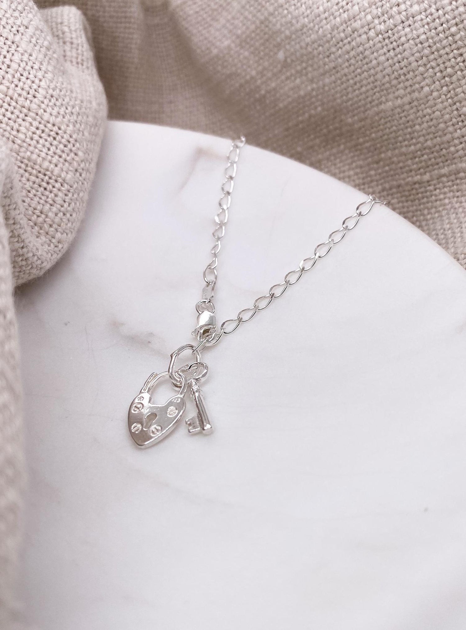 Padlock and Key Charm Curb Bracelet in Sterling Silver