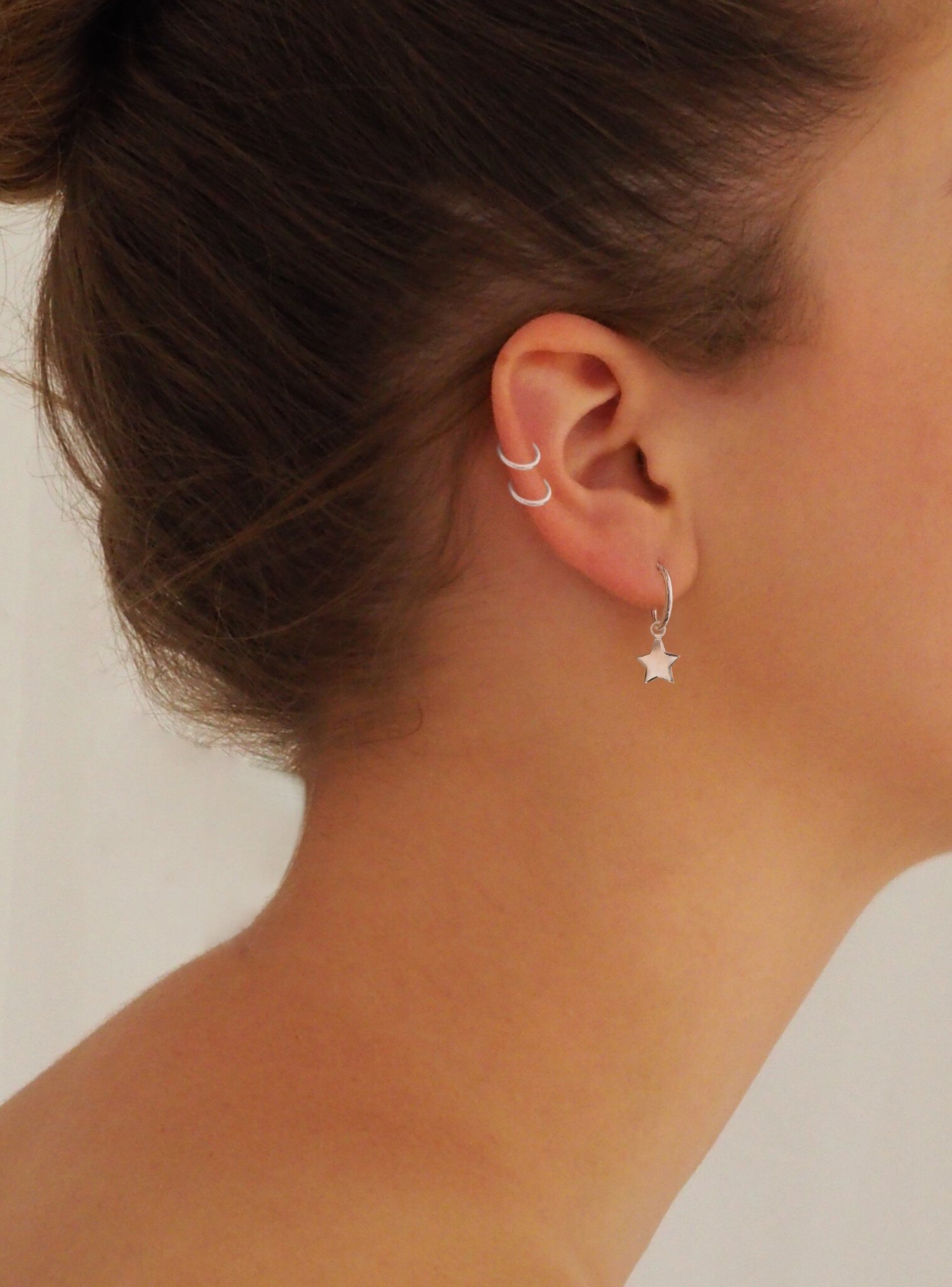 Small Hoop Earrings With Star Charms in Sterling Silver