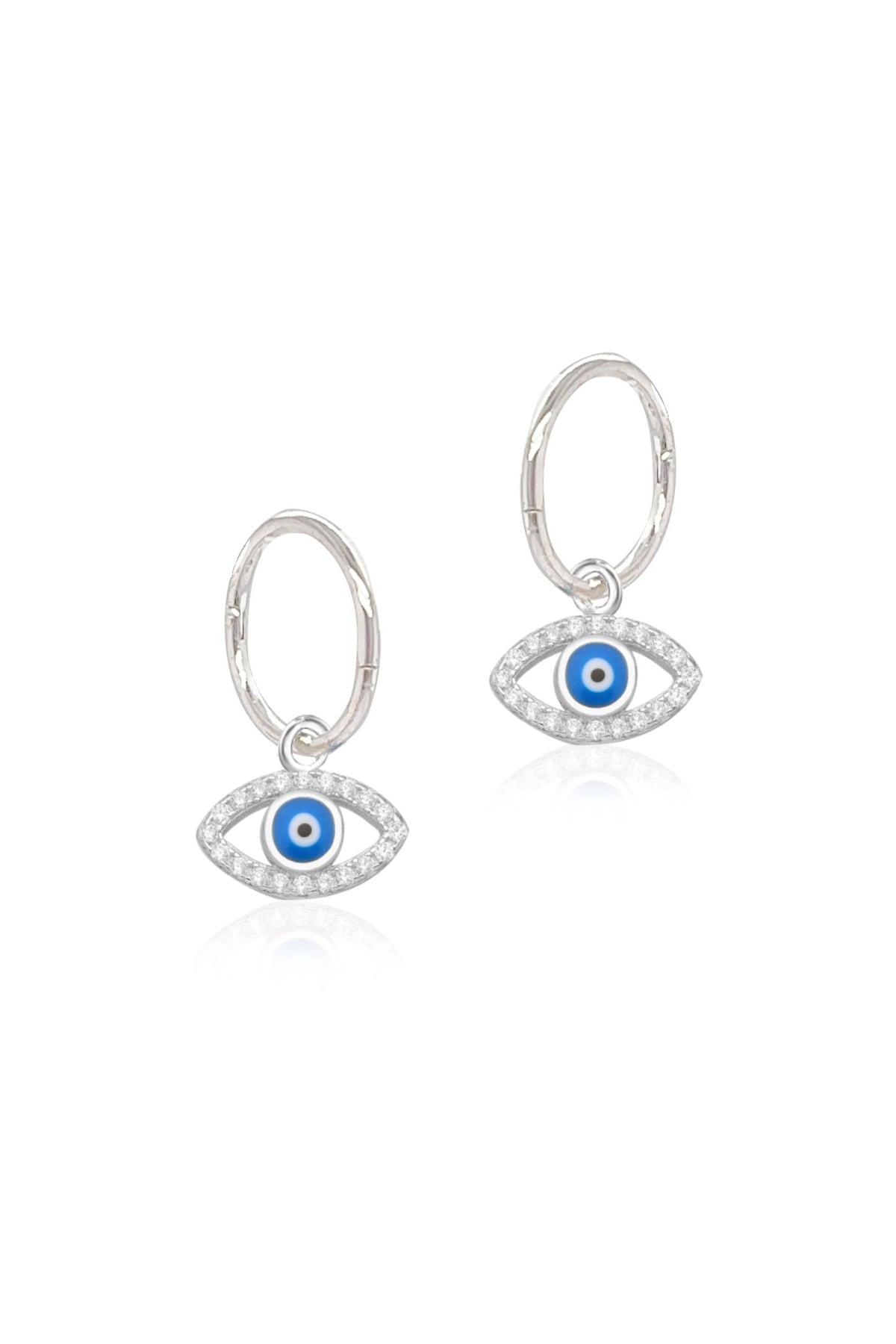Cubic zirconia evil eye charms and sleeper earrings in sterling silver on a white background
