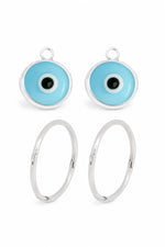 Small pale blue evil eye charms with sleeper earrings on a white background