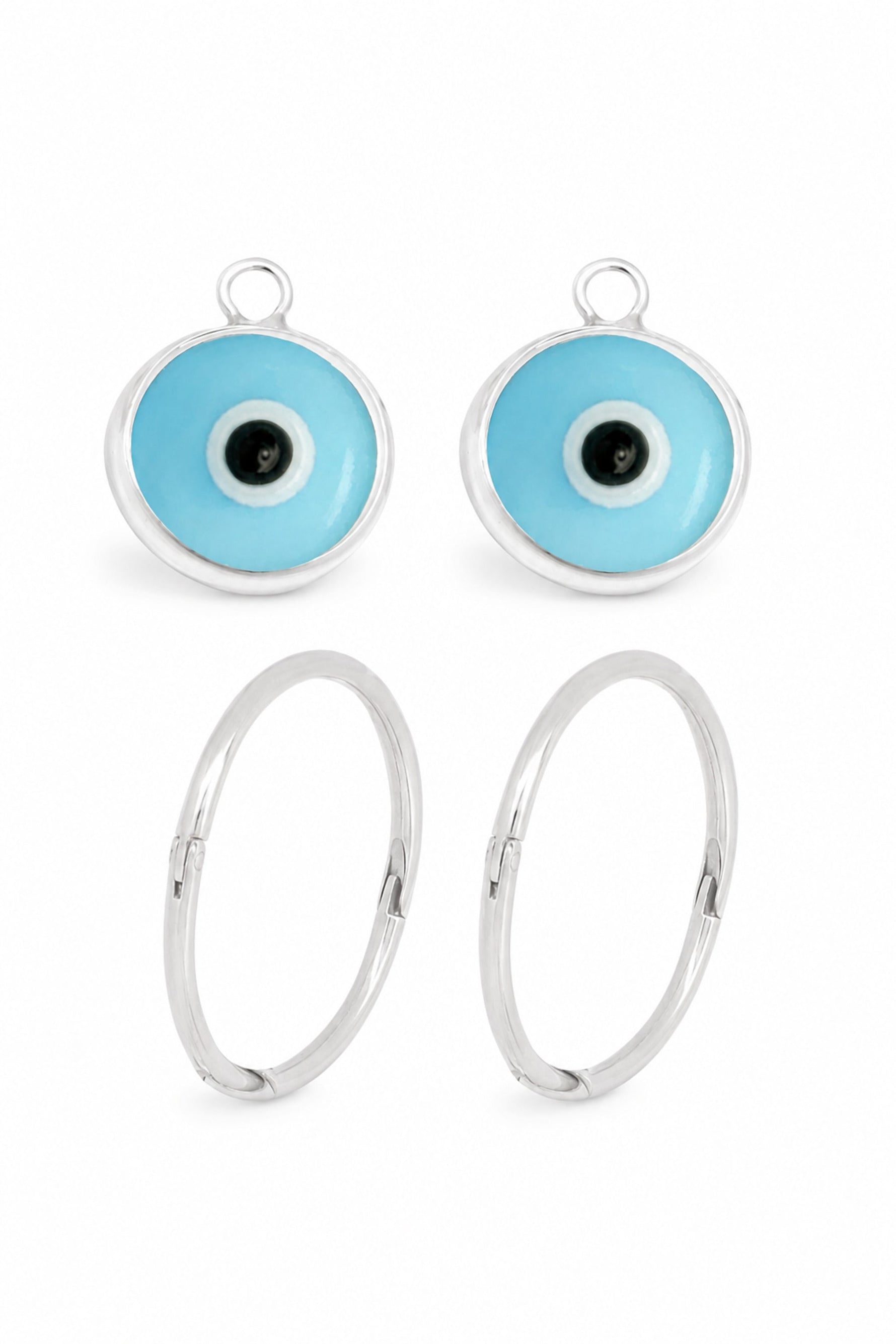 Small pale blue evil eye charms with sleeper earrings on a white background